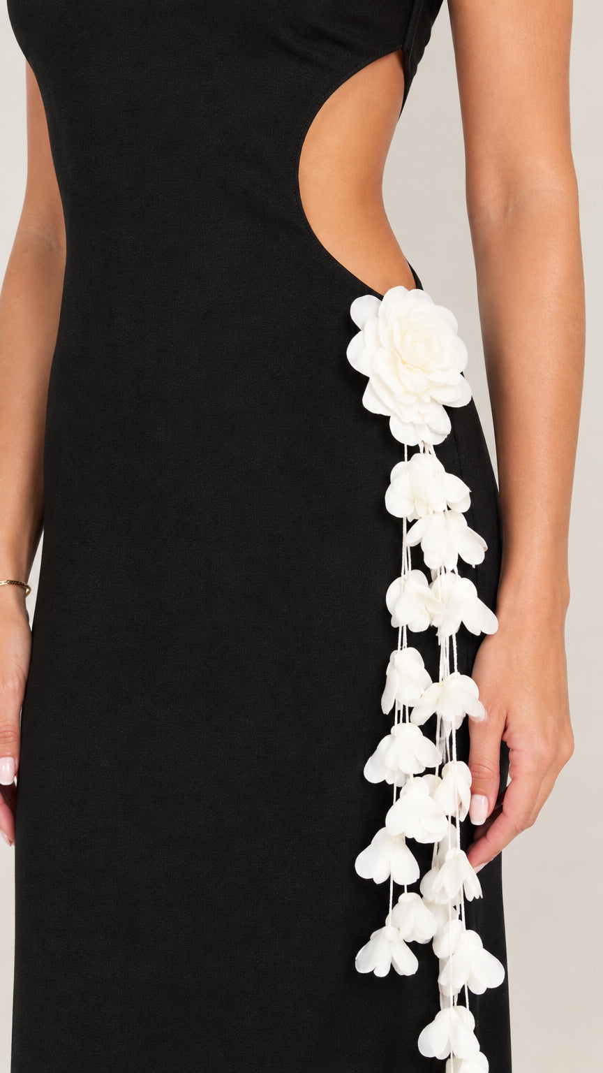 Close-up of side cutout with white cascading 3D floral applique detailing