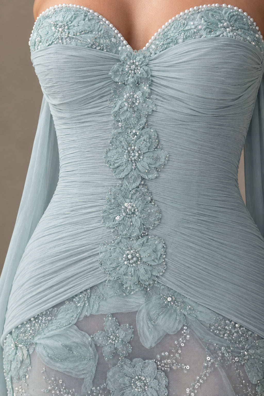 Close-up of ruched sweetheart bodice with pearl trim and floral beadwork