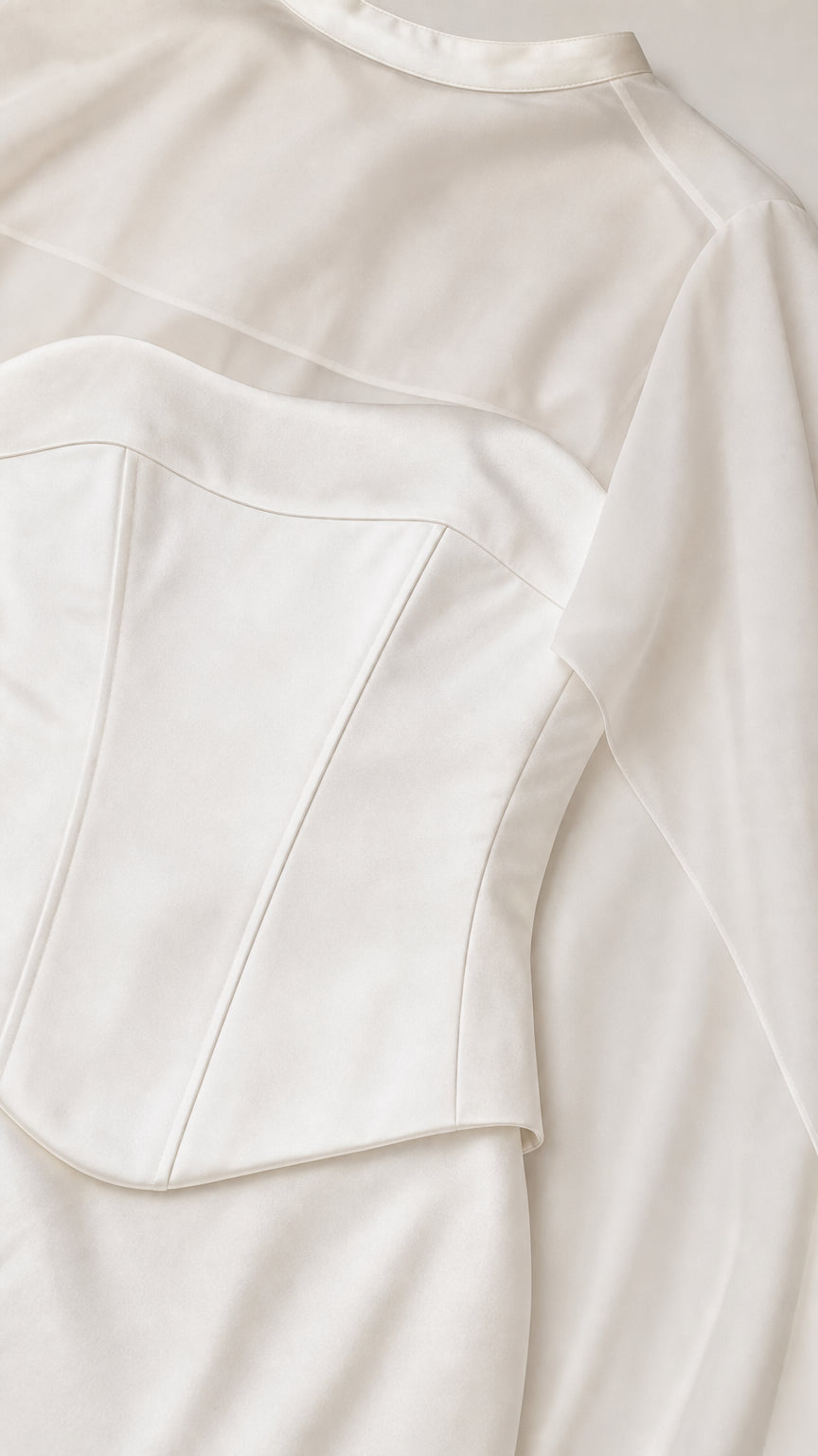 Close-up detail of structured corset seams and high sheer mock neckline
