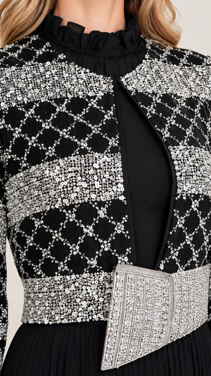 Close-up detail of geometric sequin jacket overlay and crystal waist belt