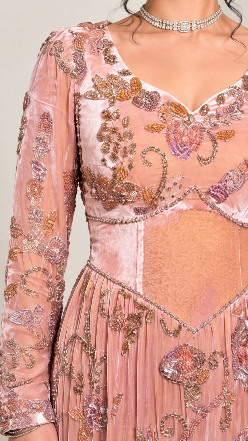 Close-up detail of sweetheart neckline, floral beadwork, and velvet panels on pink gown