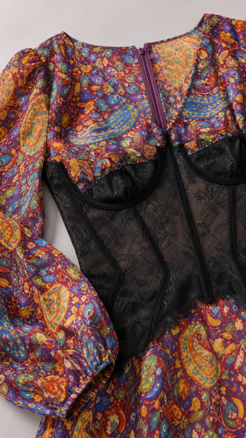 Close-up of sheer black lace underbust corset bodice and vibrant paisley fabric