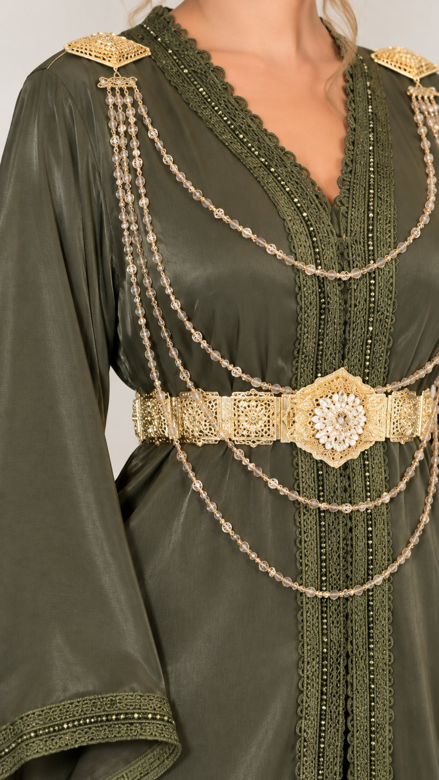 Close up of gold shoulder epaulettes and chain waist belt on Olive Green dress