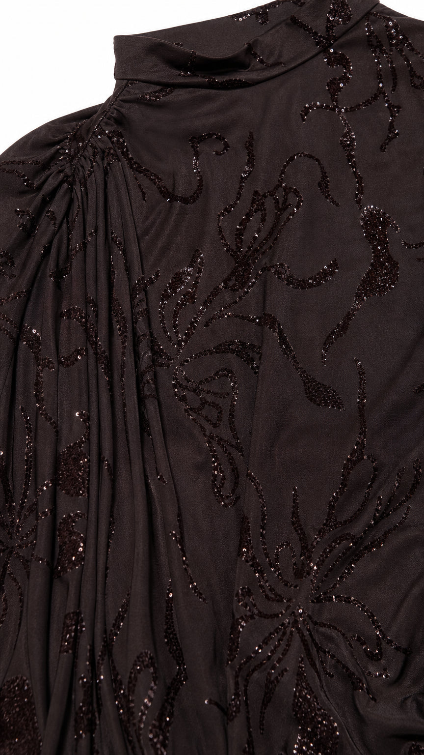 Close-up detail of shimmering floral beading on espresso fabric