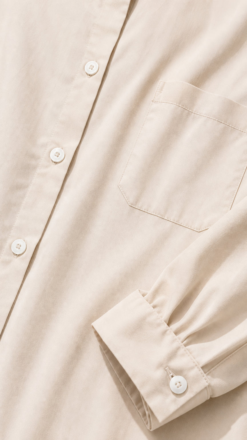 Close-up detail of shirt dress fabric, buttons, collar, and chest pocket