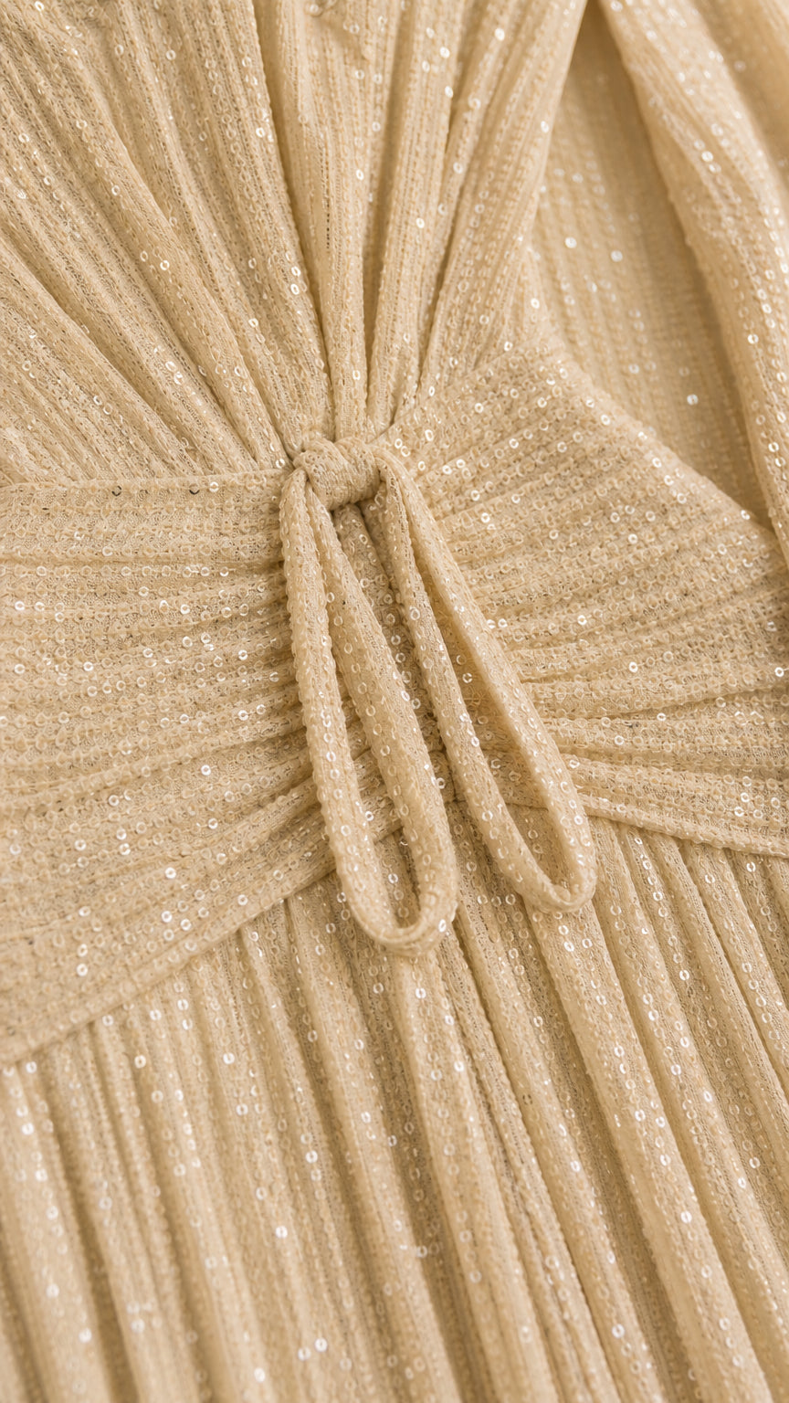 Close-up detail of champagne pleated shimmer fabric and knotted front tie