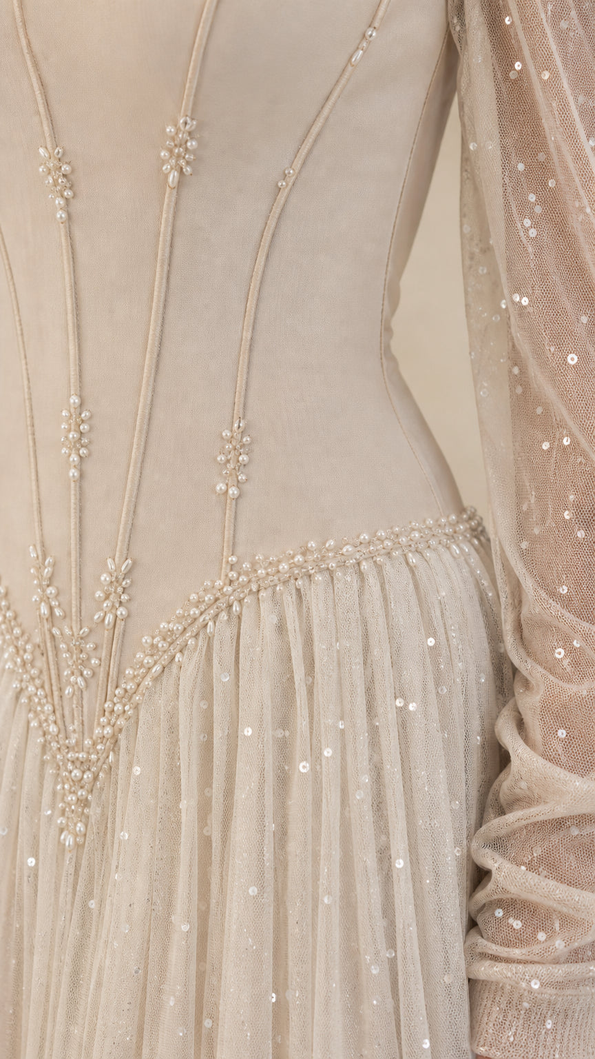 Close-up of structured corset bodice with boning lines and pearl beaded basque waist trim