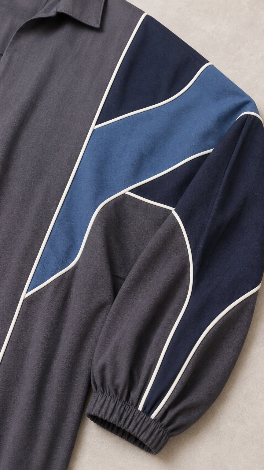 Close-up of colorblock sleeve detail with blue accents and white piping