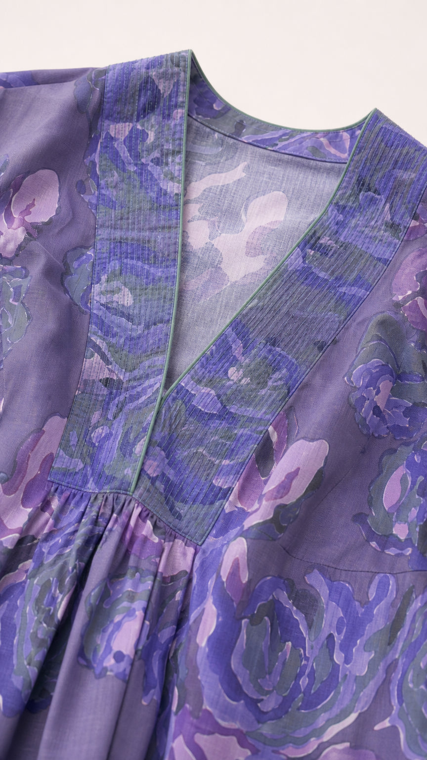 Close-up detail of V-neckline and textured trim