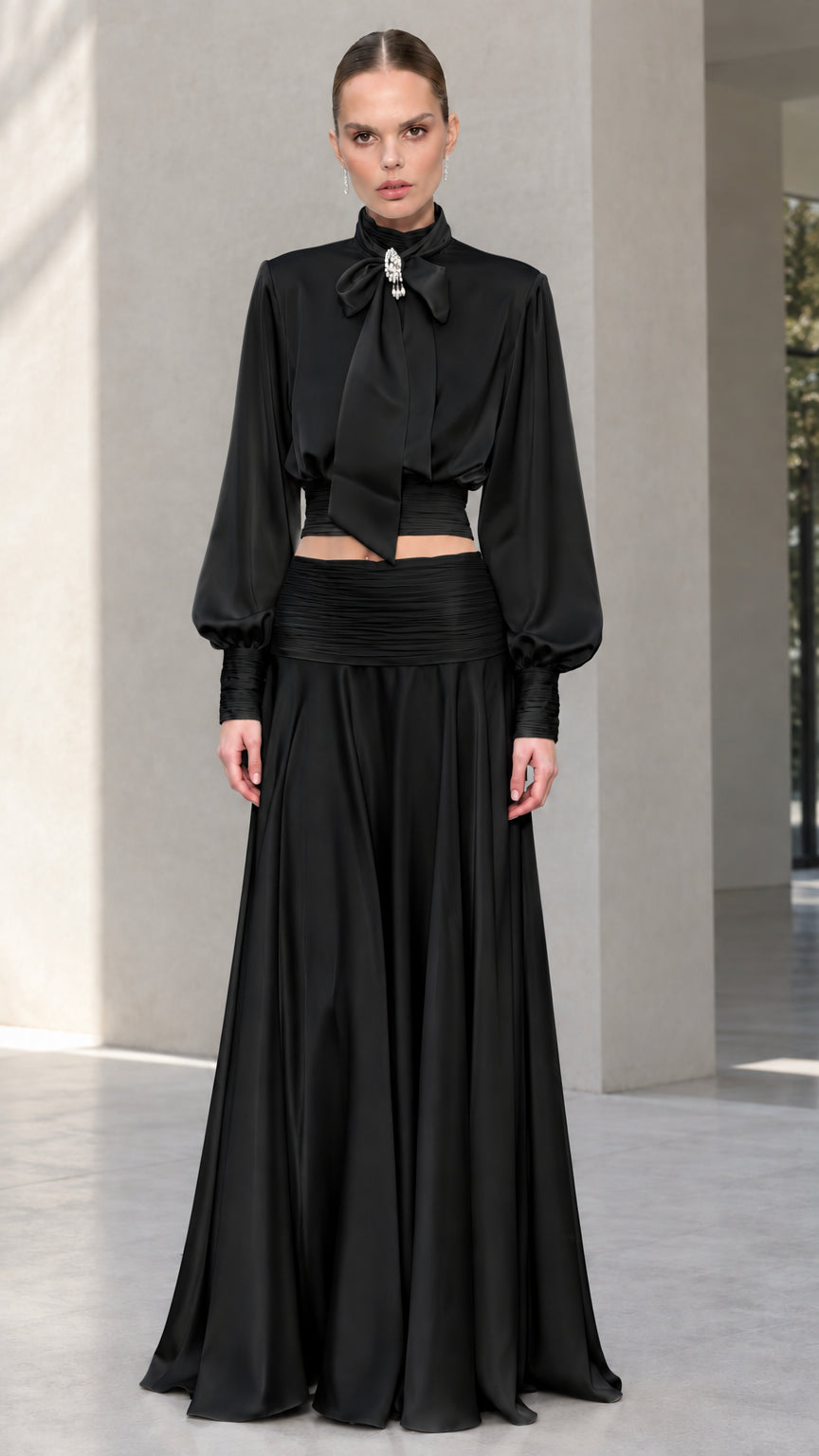 Full-length front view of black satin bow tie blouse and maxi skirt set