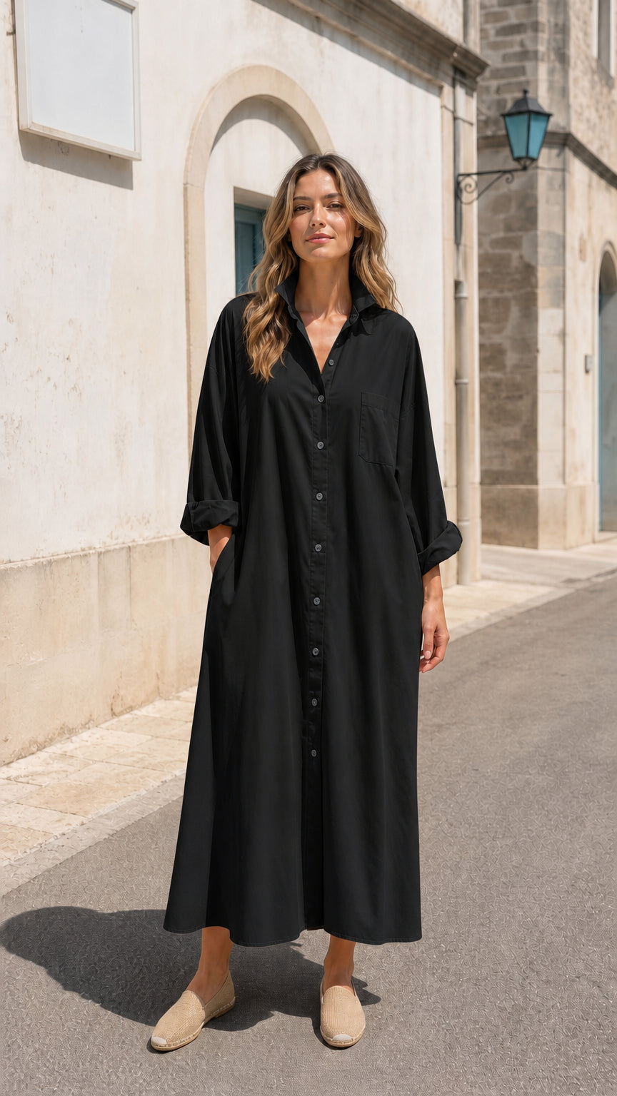 Front view of woman wearing black long sleeve button-down maxi shirt dress
