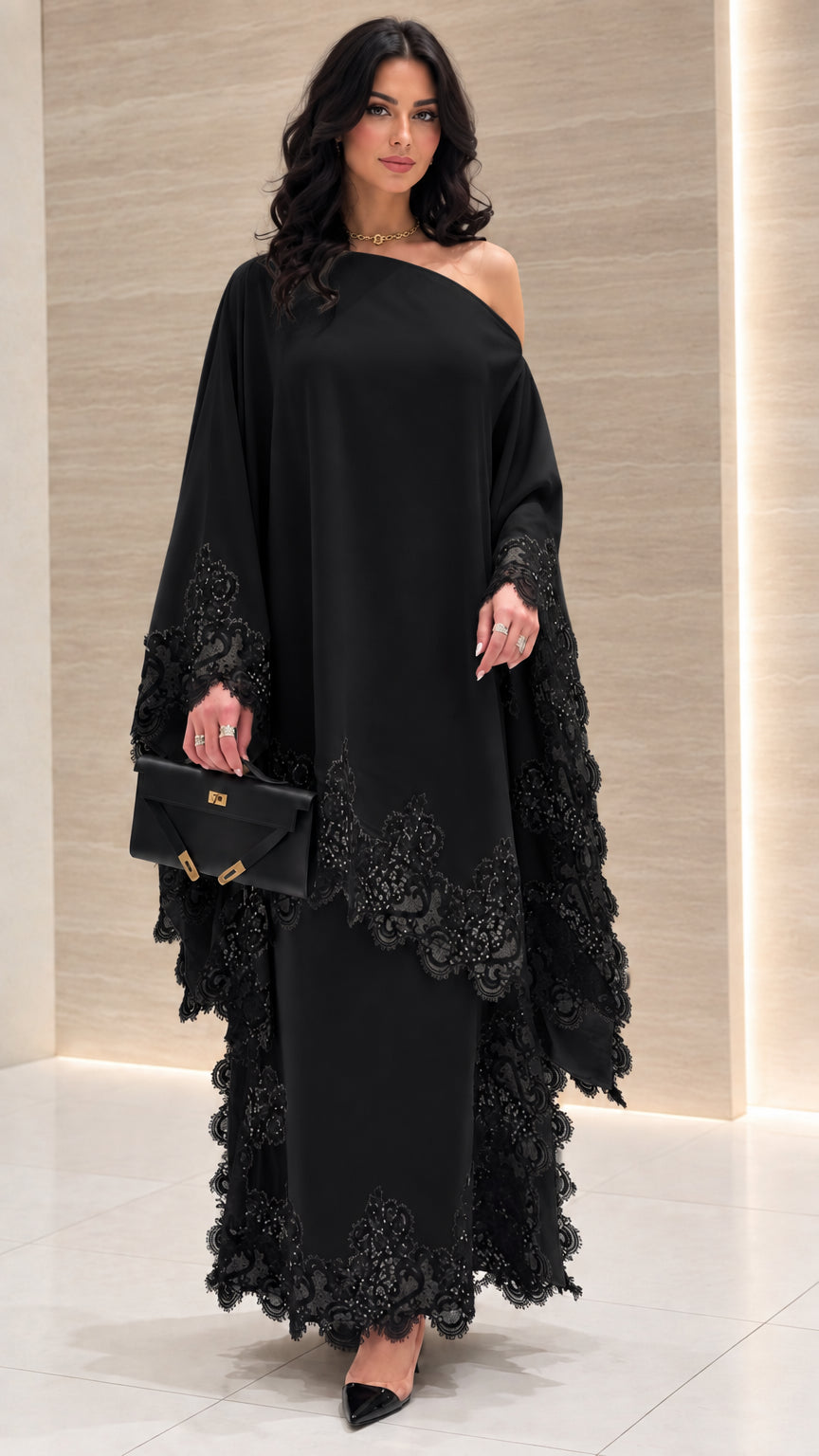 Front view of black one-shoulder draped kaftan dress with tonal lace trim