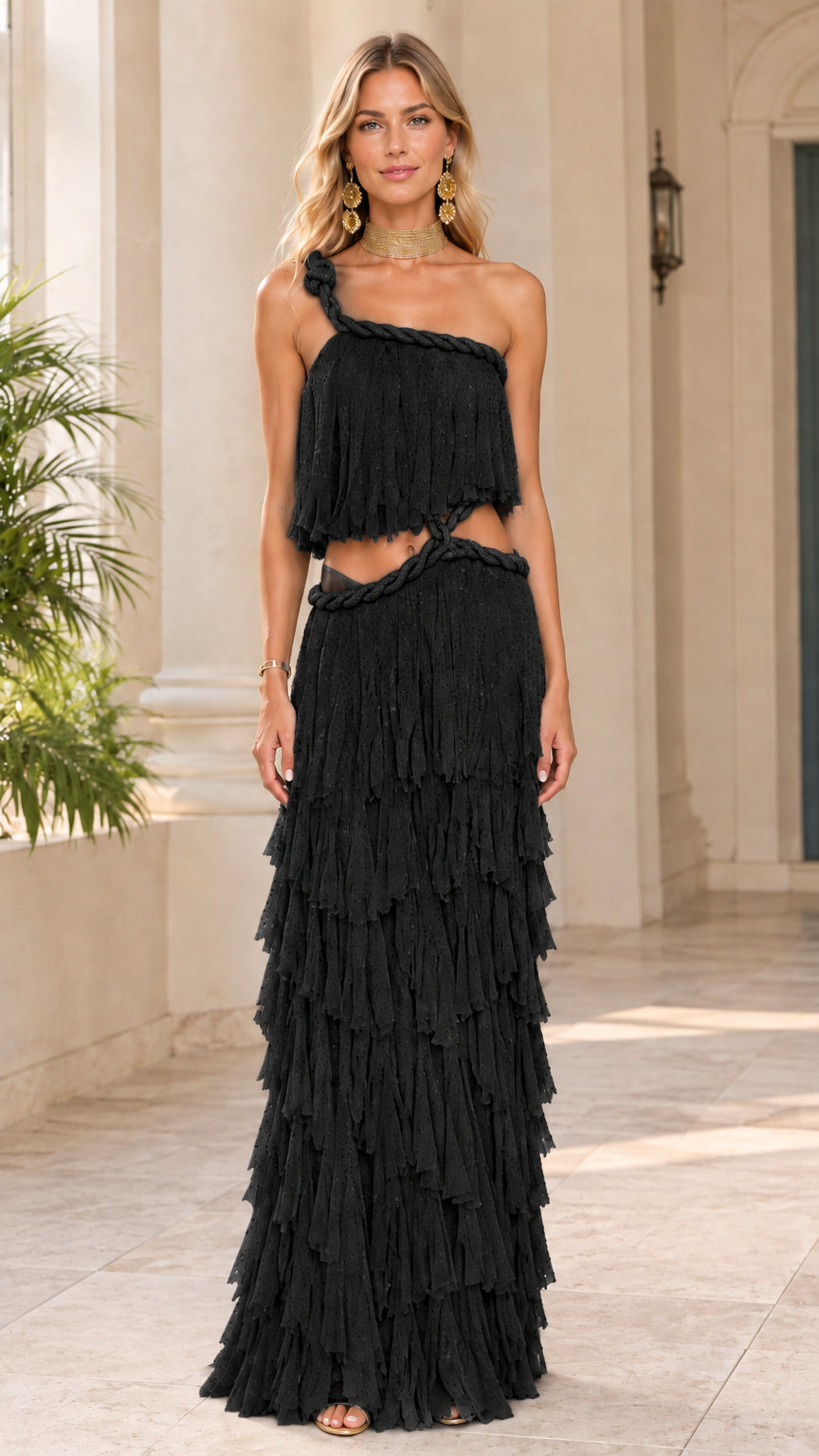 Front view of model wearing black one-shoulder tiered ruffle cutout maxi dress