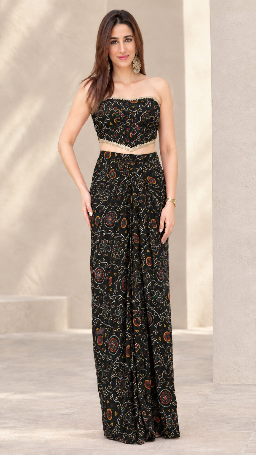 Woman wearing Black printed strapless crop top and draped skirt co-ord set
