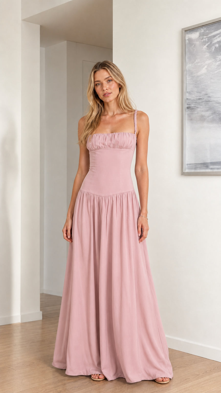 Model wearing soft dusty pink ruched bust drop waist bridesmaid dress