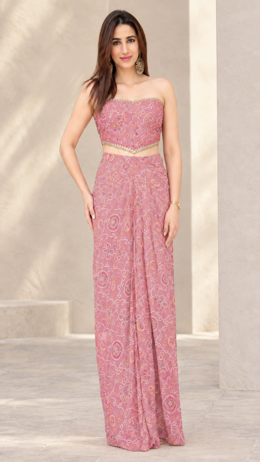 Woman wearing Dusty Pink printed strapless crop top and draped skirt co-ord set