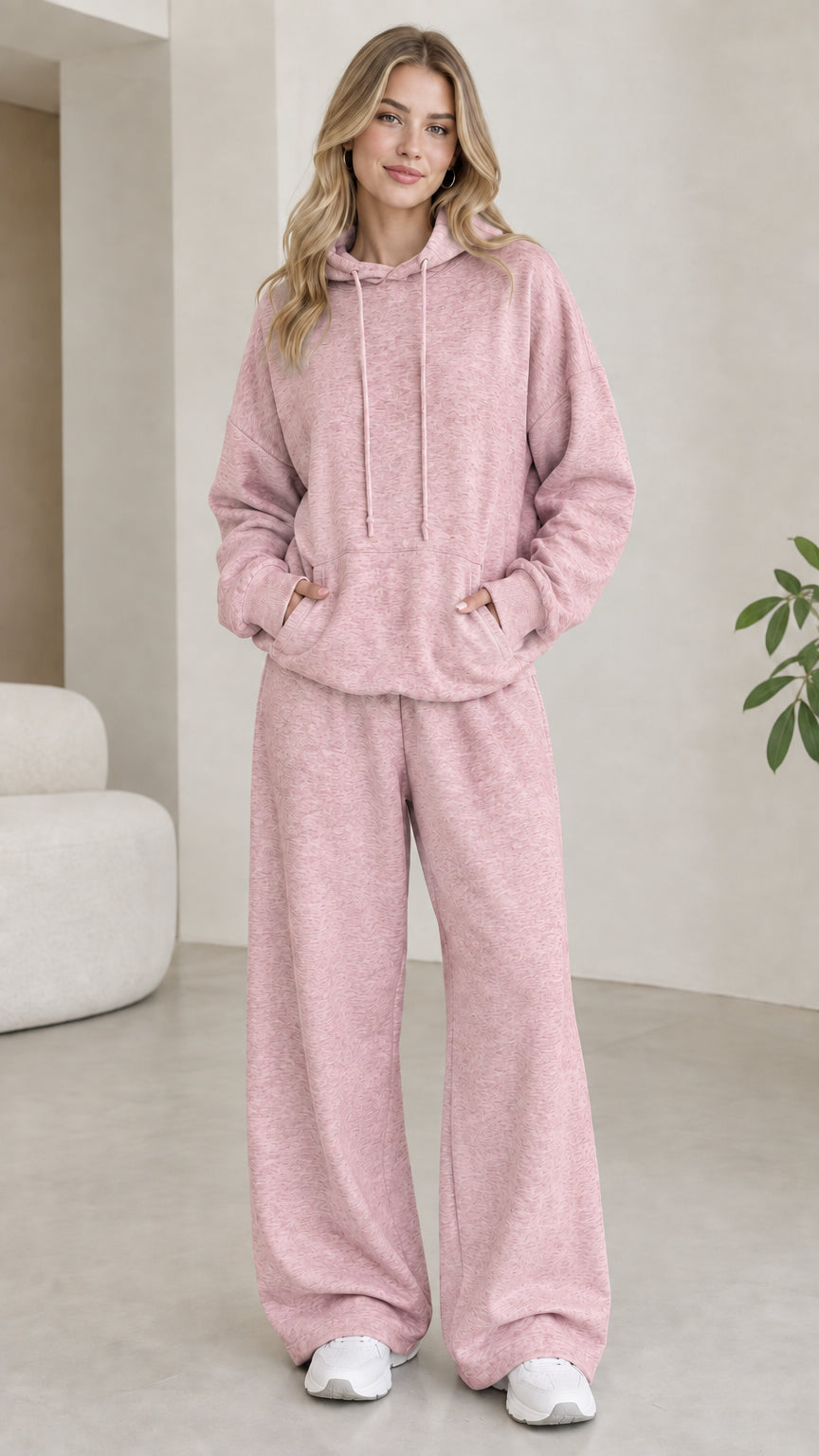 Model wearing dusty pink 2-piece drawstring hoodie and wide leg sweatpants set