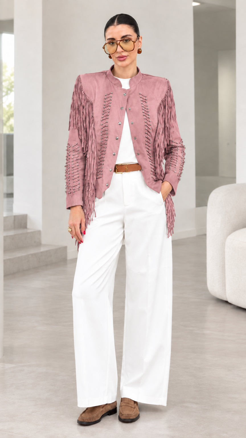 Model wearing dusty pink faux suede fringe jacket with white pants