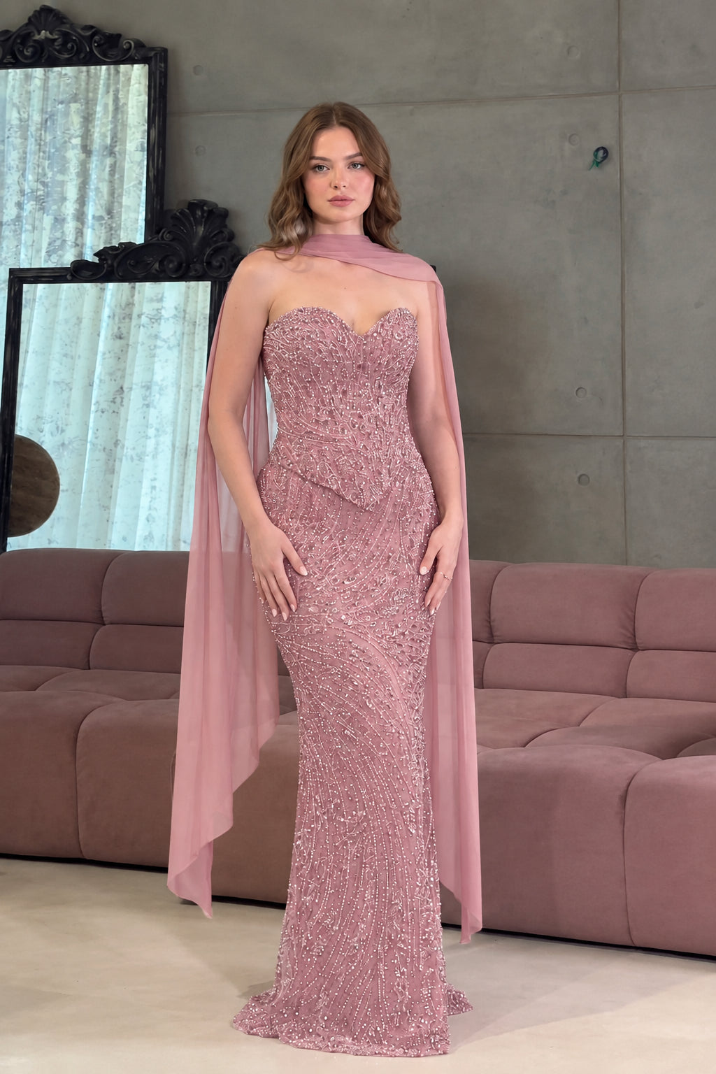 Full-length front view of the strapless sequin formal gown in dusty rose pink with matching sheer scarf cape