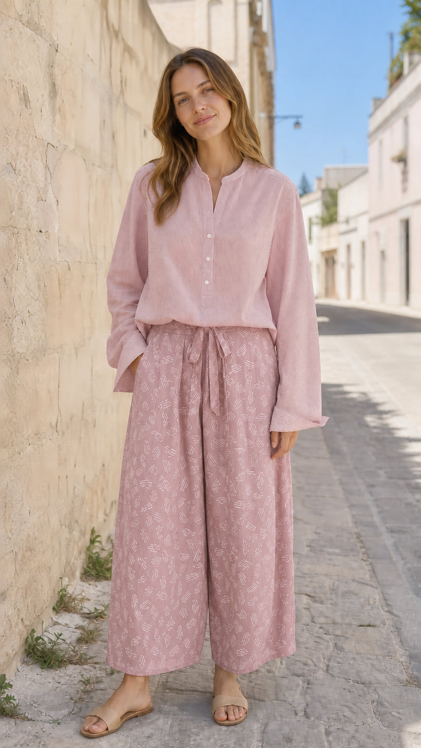Woman wearing pink two-piece blouse and printed pants set