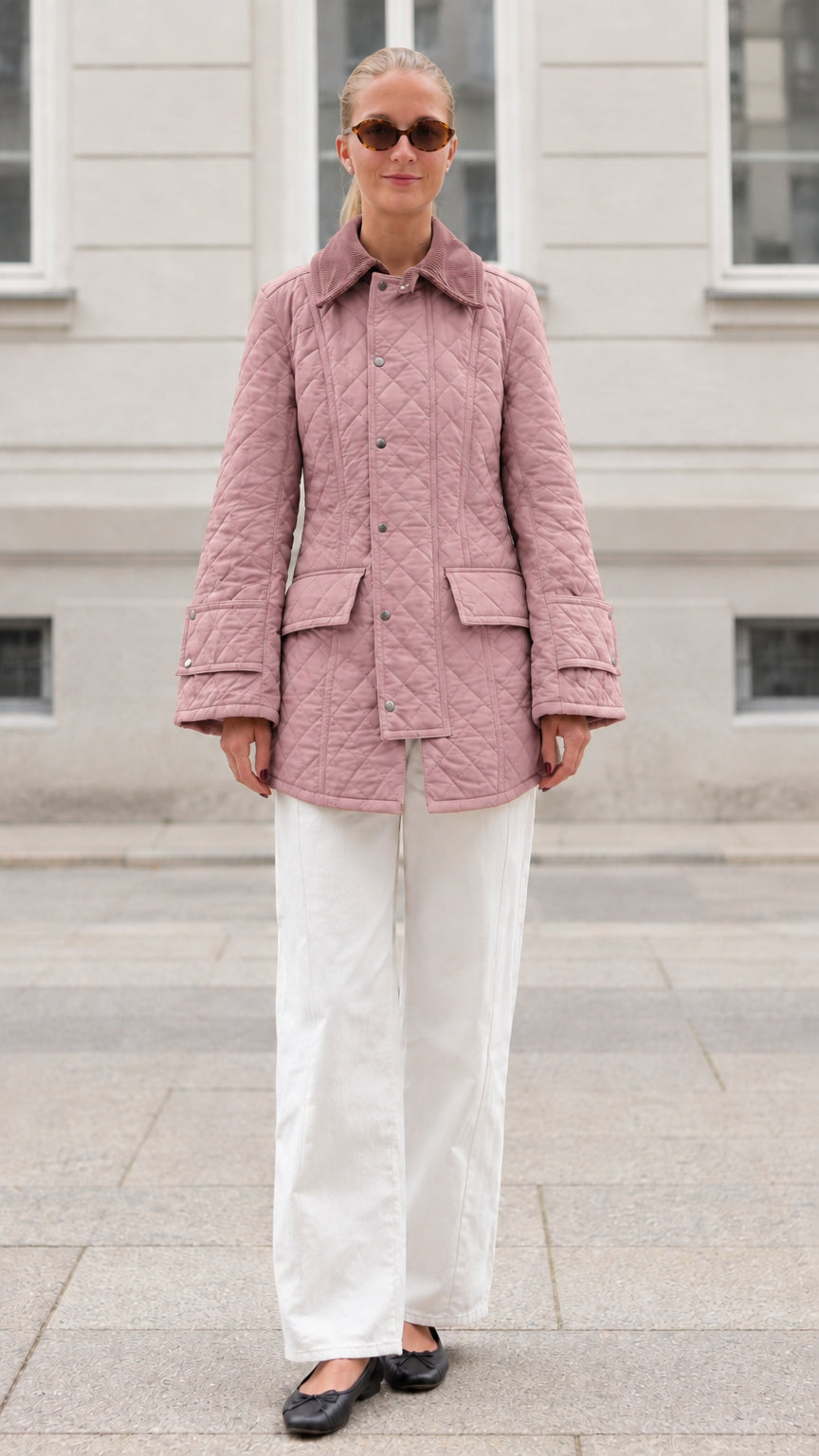 Front full-length view of woman wearing dusty pink diamond quilted barn jacket