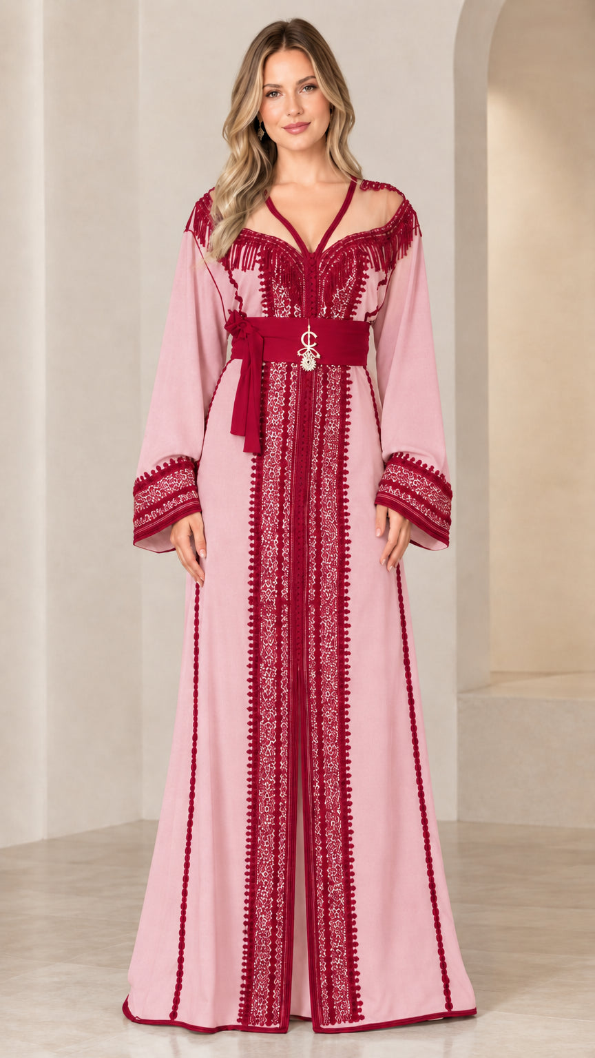 Model wearing dusty pink embroidered caftan maxi dress with maroon trim