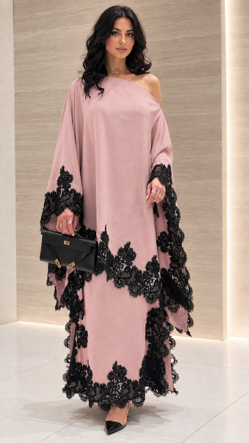 Front view of dusty pink one-shoulder draped maxi dress with black lace trim