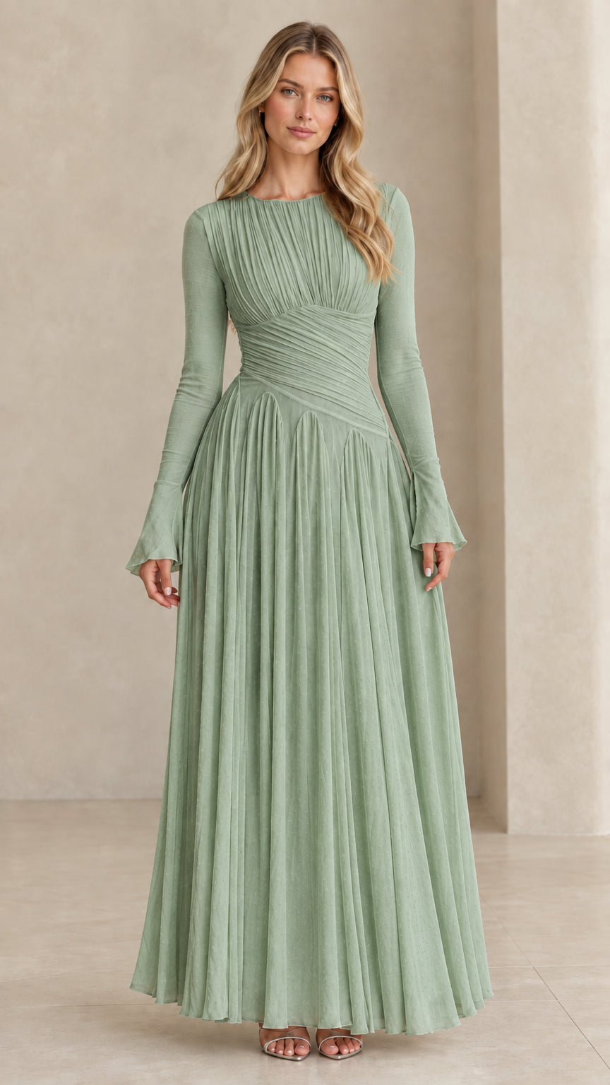 Model wearing sage green long sleeve pleated evening gown
