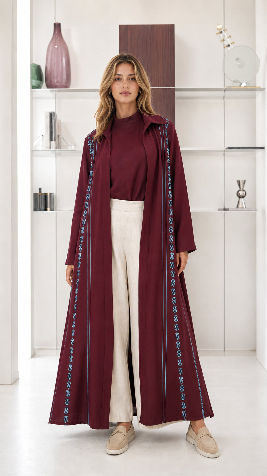 Model wearing Burgundy red open front maxi abaya duster with embroidered trim