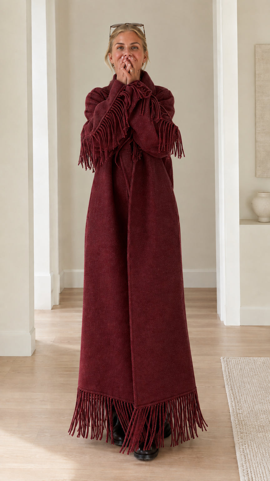 Full-length view of woman wearing burgundy wine red fringe trimmed maxi overcoat
