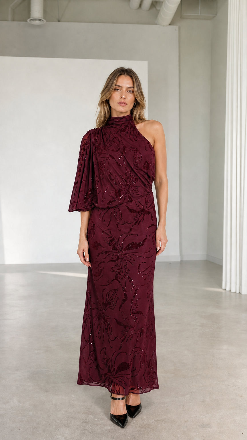 Model wearing burgundy wine one-shoulder high neck embellished formal gown