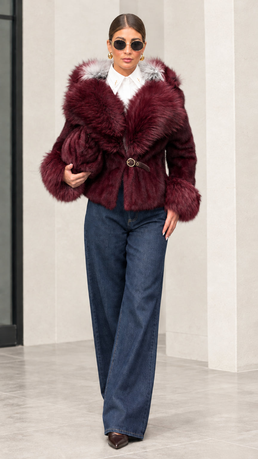 Woman wearing deep burgundy plush hooded short jacket with matching fur trim