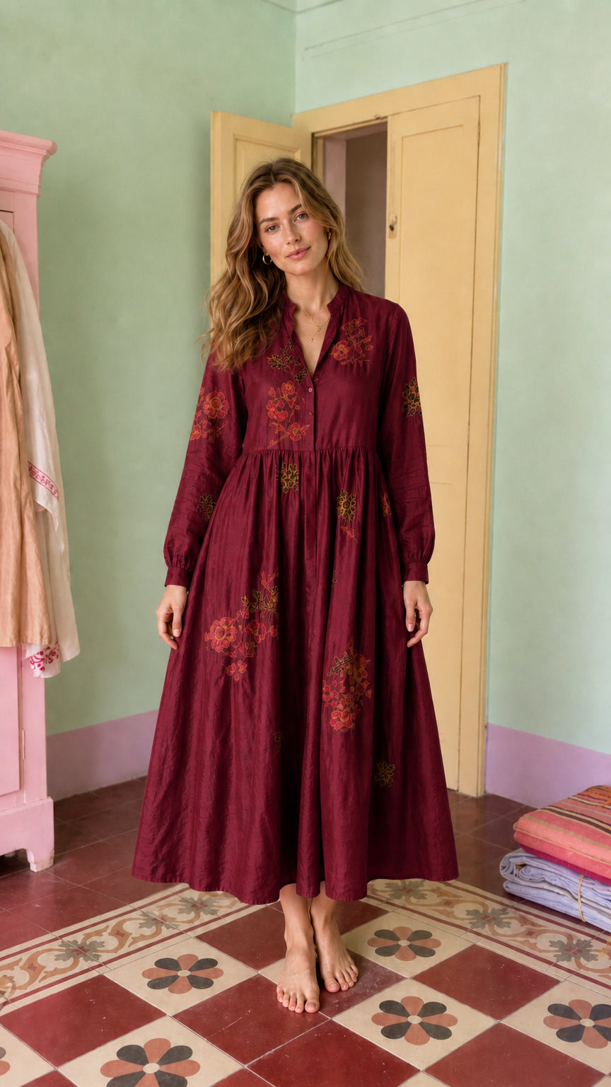 Front view of model wearing burgundy embroidered midi dress