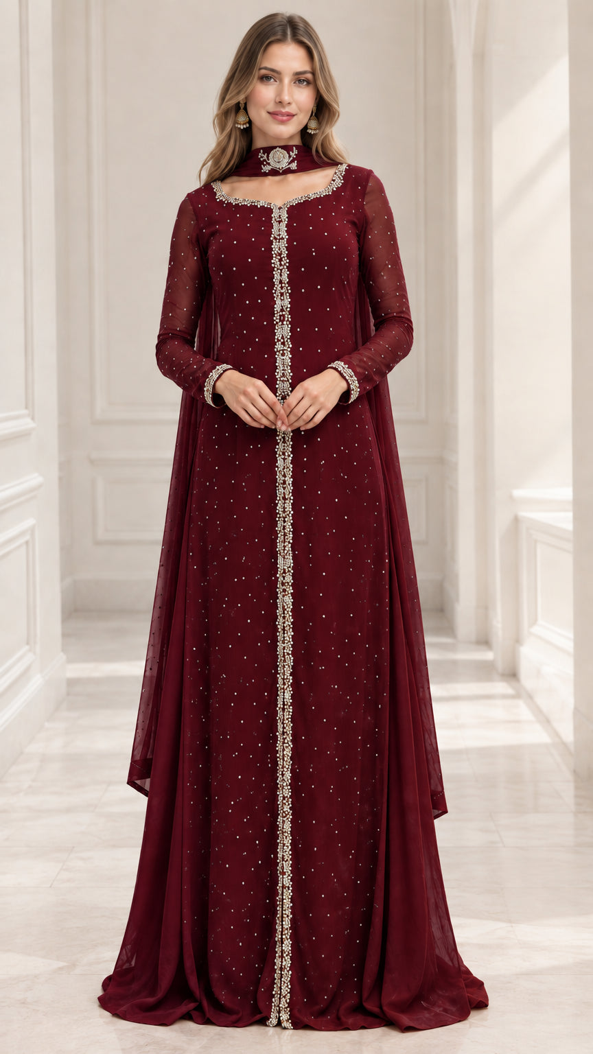 Model wearing deep burgundy long sleeve beaded formal evening gown