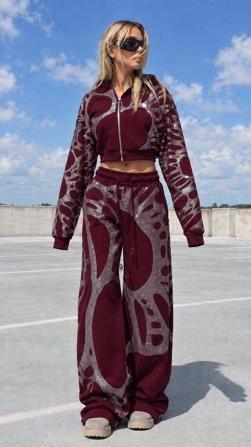 Model wearing burgundy red rhinestone cropped tracksuit set