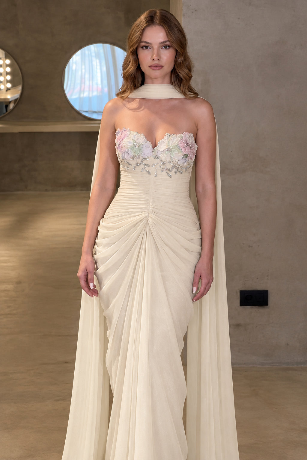 Front view of champagne cream ruched evening gown with floral appliqué bodice