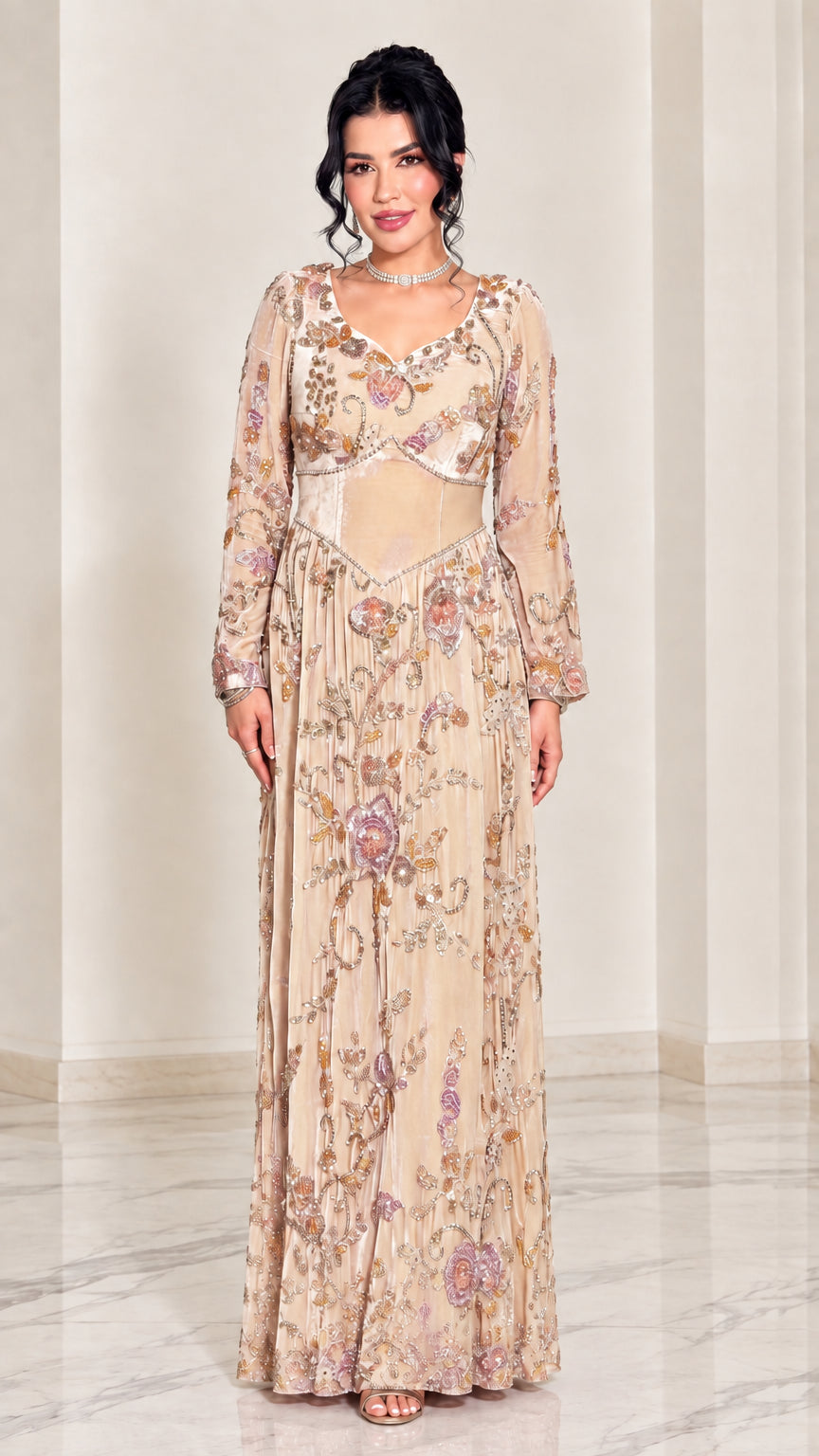 Full-length front view of champagne gold embroidered long sleeve formal gown