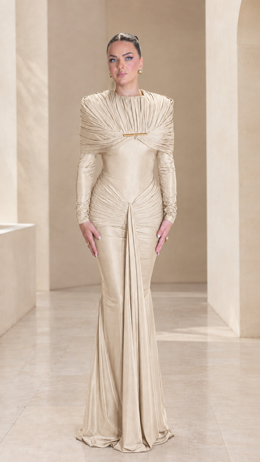 Front view of champagne beige long sleeve pleated cape evening gown